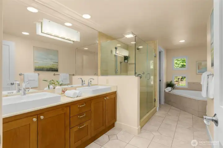 Spacious Primary suite bathroom with double sinks and an oversized soaking tub