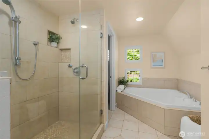 Frameless glass shower in primary suite bathroom