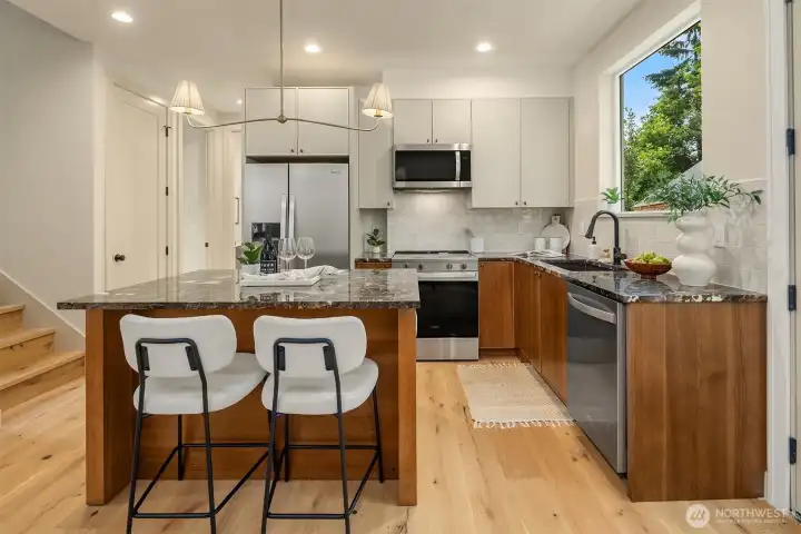 Dark emperado marble countertops and designer color palette.
