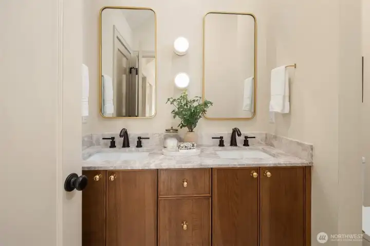 Dual vanity sinks, stone countertops and lovely wood cabinets
