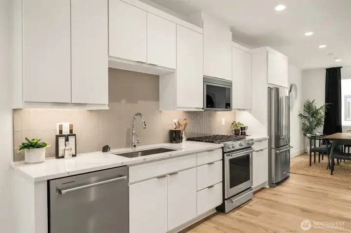 Beautifully appointed kitchen with walk-in pantry flows into open-concept living spaces Beautifully appointed kitchen with walk-in pantry flows into open-concept living spaces