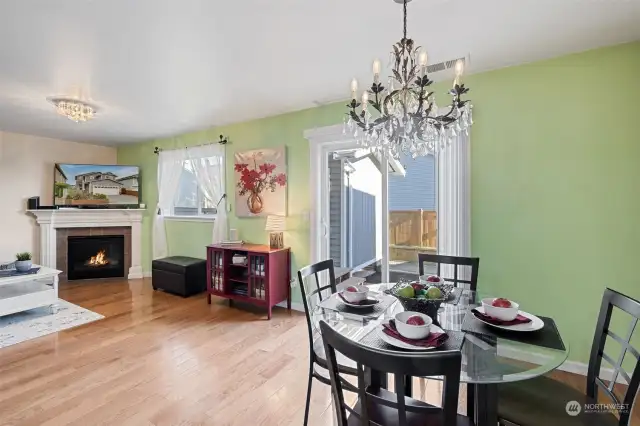 Family Room with fireplace and dining area with slider to back deck, storage shed/room and back yard.