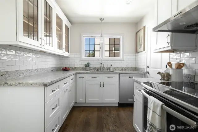 Top-of-the-line kitchen with quartizite counters, custom cabinets, stainless appliances and rich hardwoods.