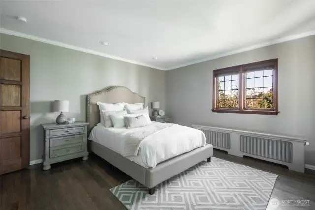 Relax in style in the large primary bedroom with rich hardwoods and serene outlooks.
