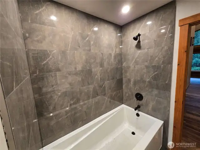 Beautiful custom tile work in extra large tub