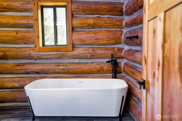 Rustic modern claw foot tub with waterfall filler