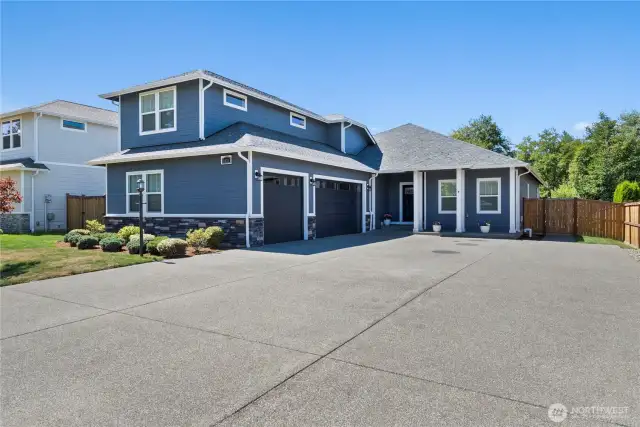Charming front porch and spacious driveway welcome you home.