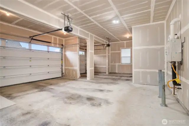 Spacious three-car garage with double and single bays, automatic openers, and a tankless water heater.