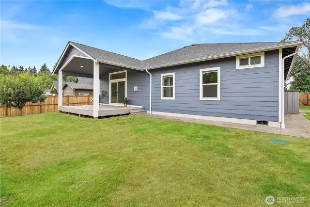 Spacious backyard with a covered deck, perfect for outdoor dining, entertaining, or simply relaxing in your private oasis.