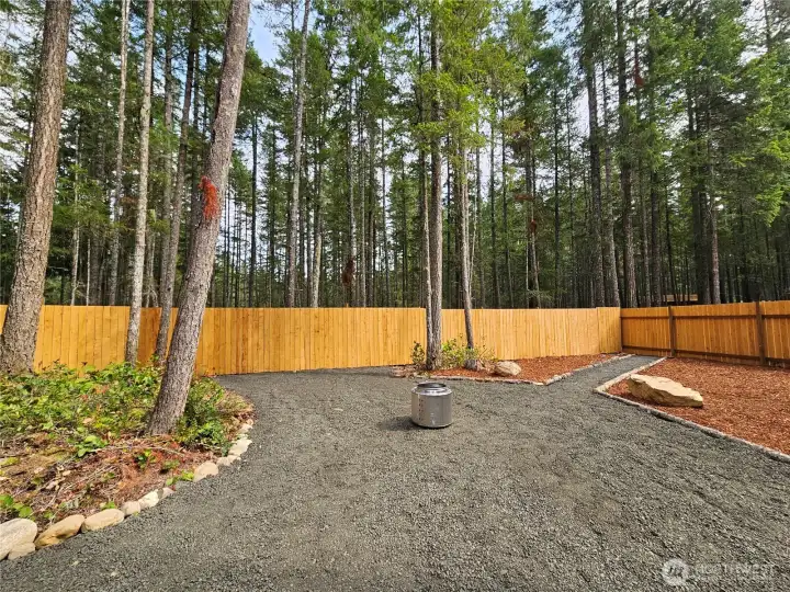Firepit area, gate to back trail & play field
