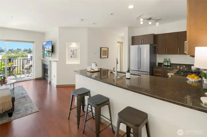 Spacious kitchen with gas range, abundance of cabinets, stainless appliances, and breakfast bar.