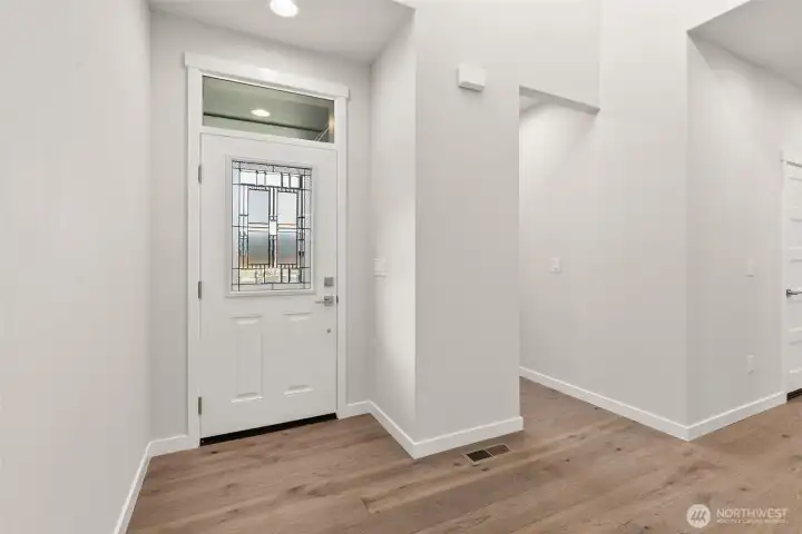 Lots of natural light and soaring ceilings great you in the entryway.