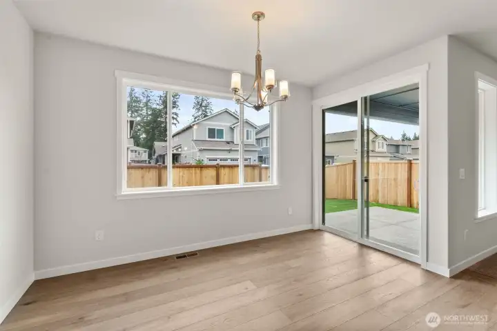 Dining nook off kitchen with slider door to back patio area.