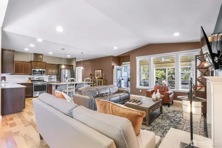 View of living and kitchen from dining area with views of the lake through the custom sunroom