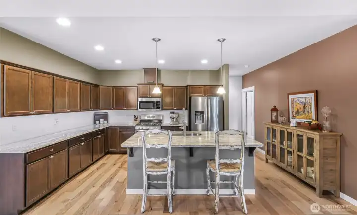Large open kitchen with stainless steel appliances and extra large island, perfect for entertaining