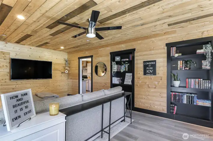 Lower level ADU is about 800 square feet, main living area with cedar planked walls and built in shelving for coziness!