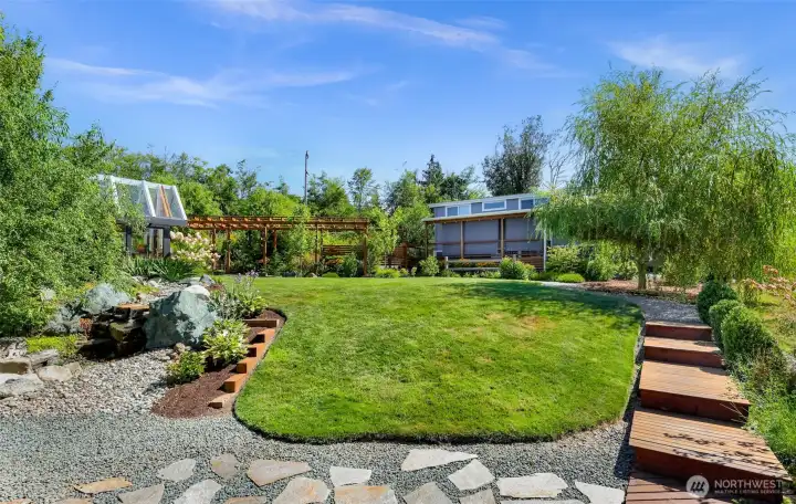 Walking through this property is so gorgeous, this walk way will lead you to another custom built pergola and potting shed AND the additional Tiny Home on the property