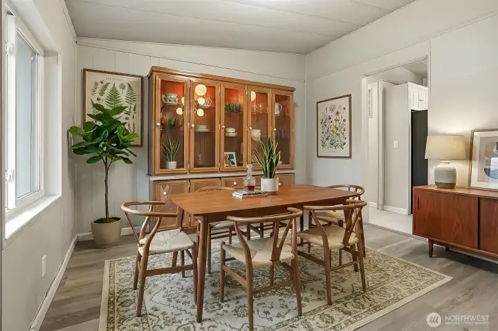 Formal dining room with a built in hutch and new LVP flooring - virtually staged photo