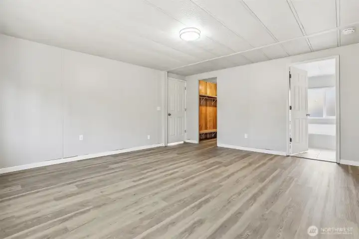 Master bedroom suite with vaulted ceilings, new LVP flooring, walk in closet and updated 4 piece bathroom