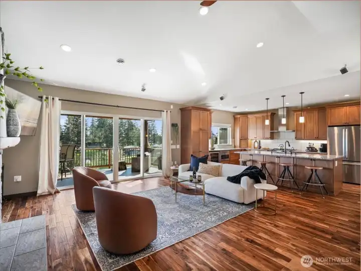 A well designed open-concept space highlighted by rich Acacia hardwood flooring extends throughout the living, dining, and kitchen areas, creating a warm and cohesive feel.