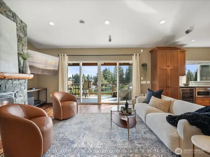 The living area extends effortlessly to a covered outdoor retreat, complete with integrated surround sound for an enhanced entertaining experience.