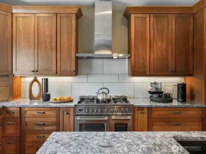 Designed for the culinary enthusiast, the kitchen features a stainless steel 6-burner gas cooktop with exhaust hood, double convection ovens, and wine fridge, a perfect combination for entertaining family and friends.