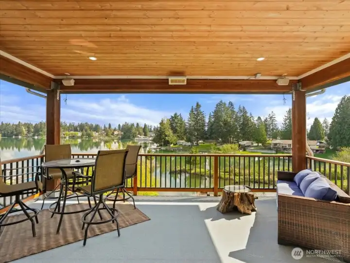 The covered outdoor living area  off the main living space is equipped with surround sound and heaters for year-round comfort and enjoyment.