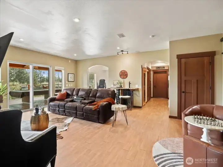 Lower level features an expansive 80-foot deck, offering exceptional space for outdoor living and entertaining. A covered portion ensures year-round enjoyment, allowing you to relax comfortably in any season.