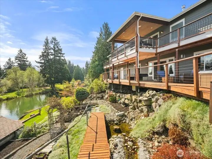 The entire property is beautifully landscaped, featuring mature fruit trees and vibrant flowering bushes throughout with motion detectors for walkway lights. This lush setting creates a serene and picturesque outdoor environment to enjoy year-round.