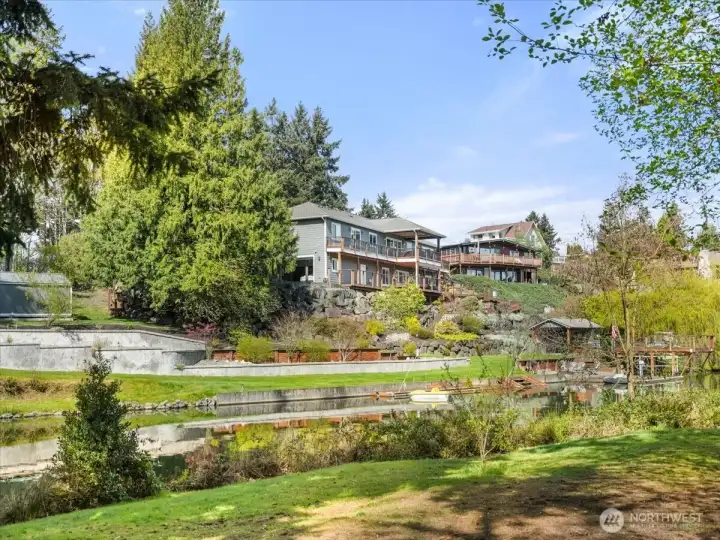 This scenic view is from additional property included in the sale, offering an exceptional extension of your waterfront lifestyle. Equipped with water access for added convenience, it’s an ideal space for guests to camp and enjoy the lakefront setting.