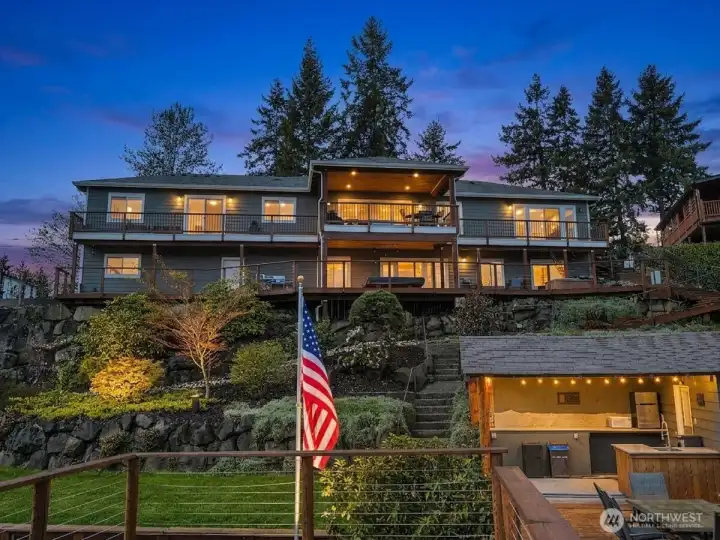 This extraordinary Lake Tapps waterfront estate offers 350 feet of prime shoreline, combining luxury living with unmatched outdoor amenities and breathtaking views. The beautifully designed home, private docks, boat launch, cabana, and expansive entertaining spaces to the ADU, sauna, hot tub, and lush landscaped grounds, this property delivers a rare opportunity to experience the ultimate lakeside lifestyle.