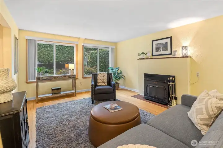 This living room gets excellent natural lighting from the   Western exposure. You will love the cozy wood burning fireplace