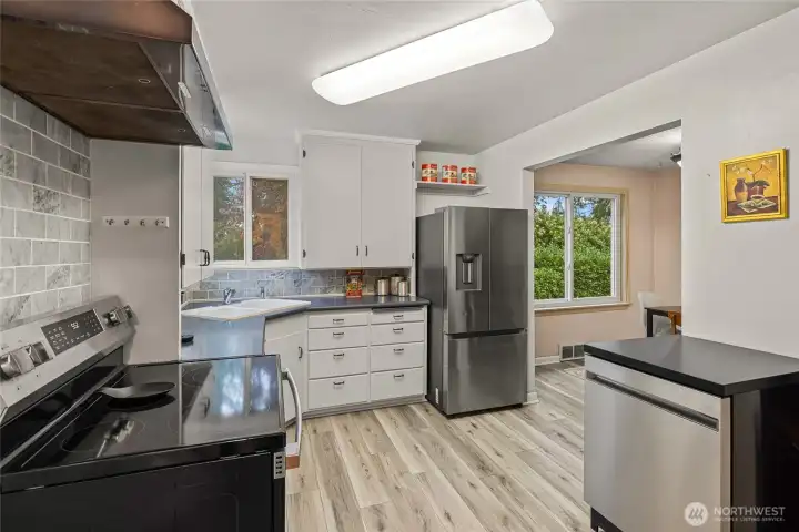 Kitchen with new stainless steel and flooring appliances.