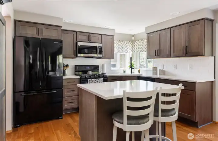 Newly refreshed kitchen with all new cabinetry, quartz countertops, pull out drawers in pantry and newer appliances