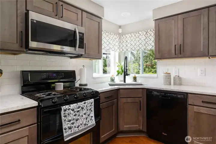 Updated kitchen with quartz countertops and gas range