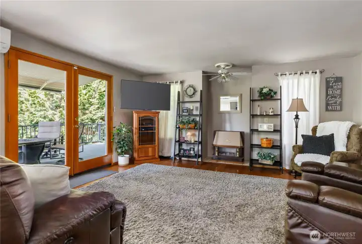 Family room opens to large covered, composite deck overlooking beautifully landscaped yard