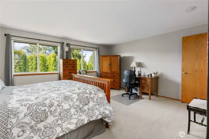 Primary suite overlooks private backyard