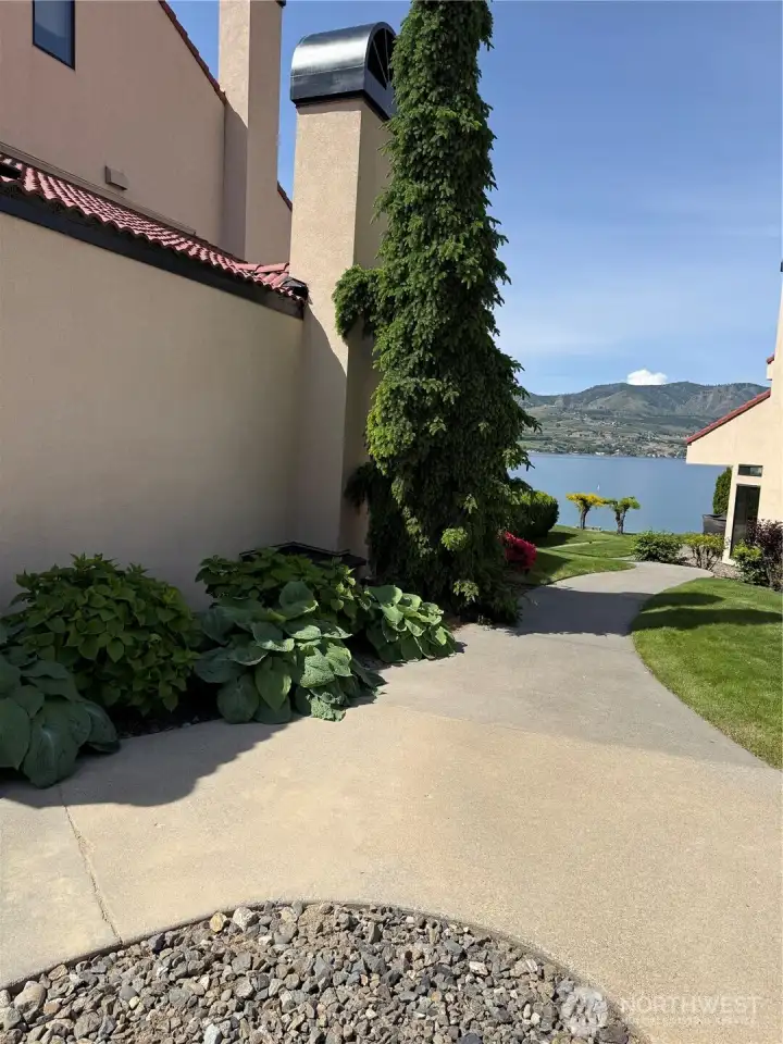Paved walkways and mature landscaping leads right to the front doorway.