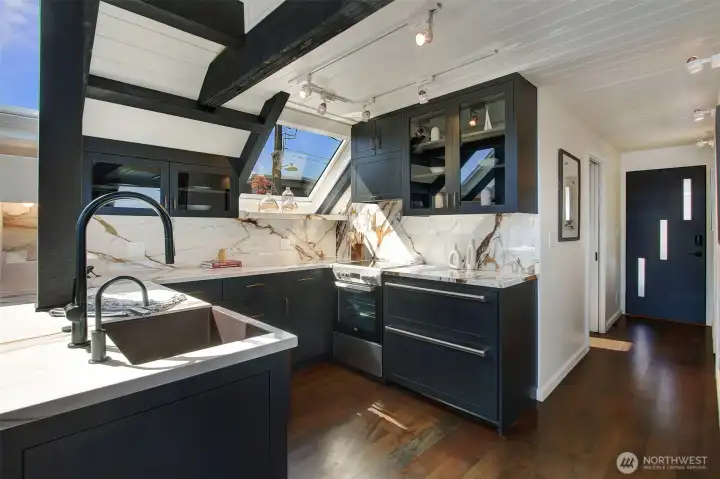 To maximize counter space and cabinet storage, an under counter refrigerator is utilized.