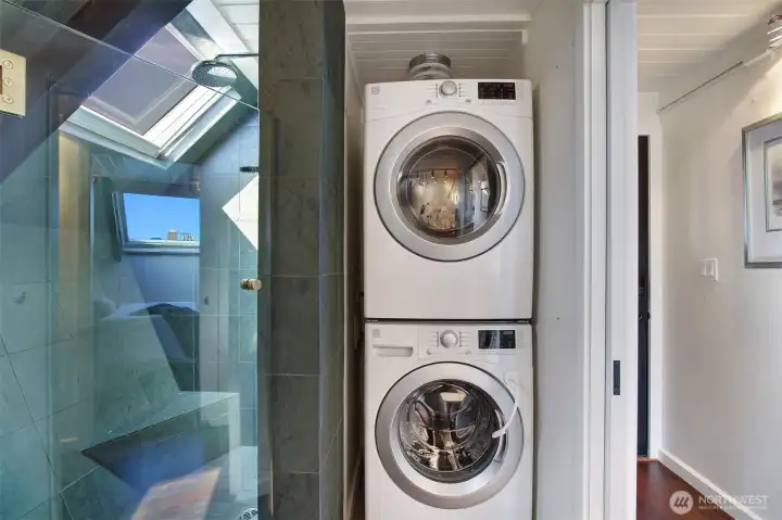 The walk in shower is quite large and bonus a window for yet more views.  Convenient stackable washer and dryer.