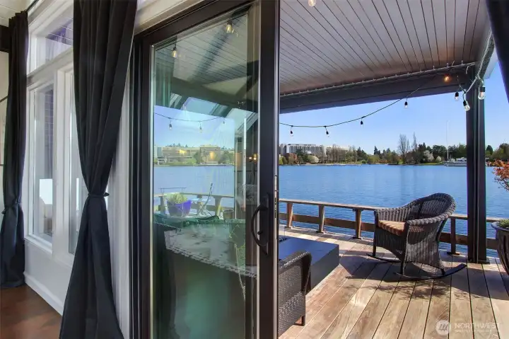 The large front facing IPE deck lends itself as a whole separate room.  The canopy (which can be removed) supplies shade from the sun, a roof from rain, and a retractable screen for privacy,