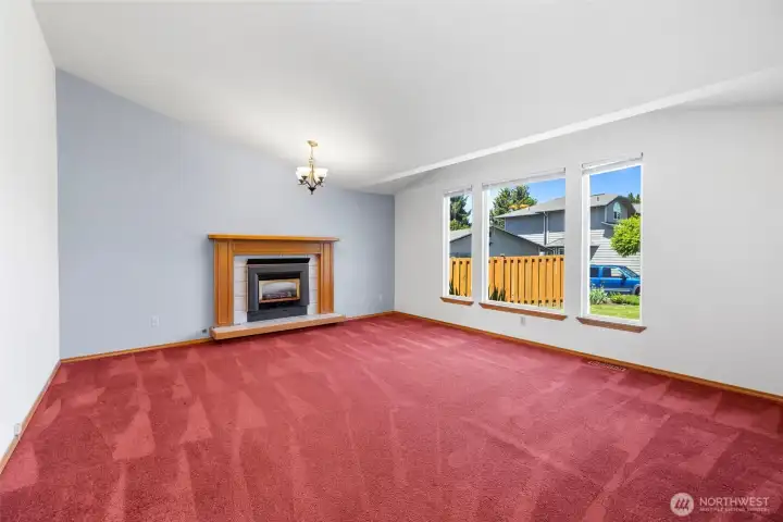 Living room with gas fireplace insert and wood mantel Living room with gas fireplace insert and wood mantel