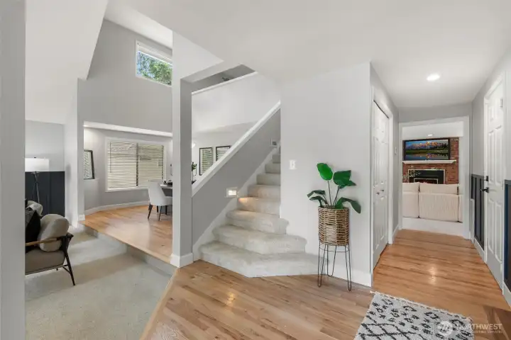 With a central entrance, the formal front family room is left-adjacent, while a center hallway takes you to the rear living room, past the garage entrance and coat closet.