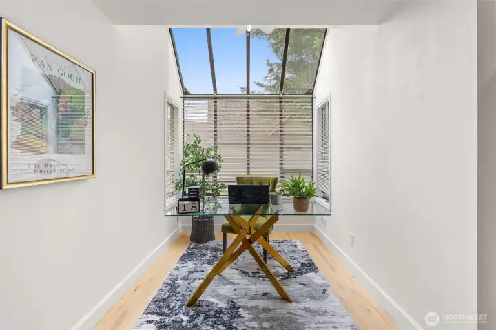 This nook off of the kitchen may be used for a breakfast table, or as an office.