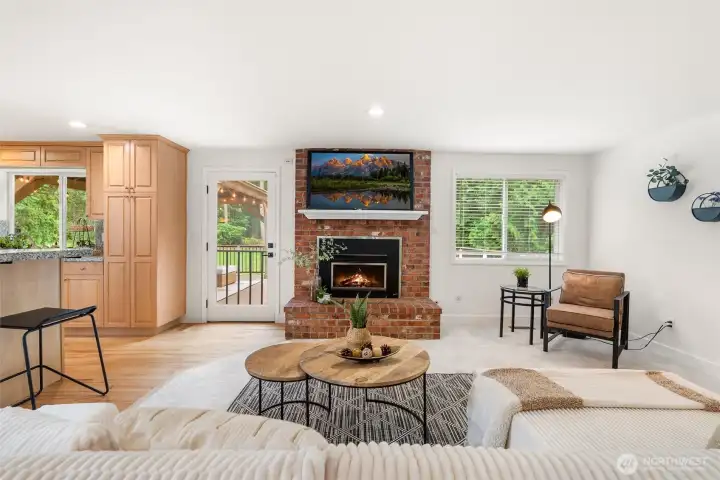 An exposed brick fireplace offers character in this modern masterpiece.