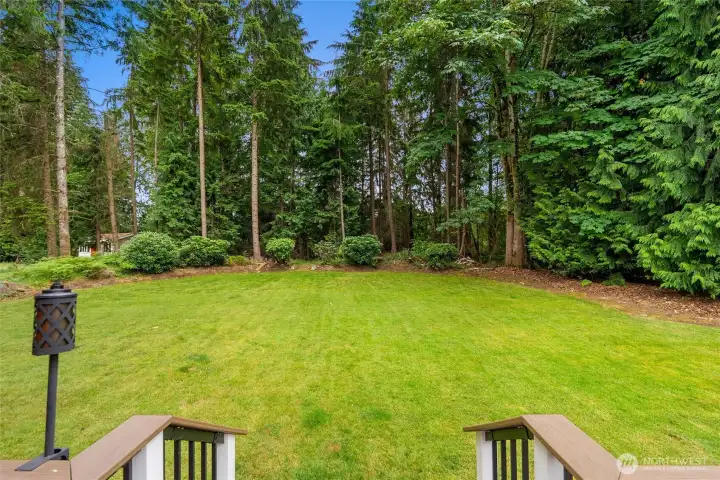 Sited on nearly half an acre, the rear deck opens to the expansive backyard.