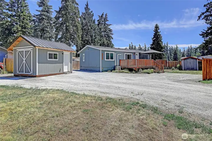 Detached shop, storage shed, ample parking, and a spacious deck create the perfect blend of functionality and outdoor living.