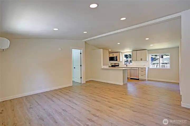 Bright, open-concept living area connects the kitchen, dining, and living spaces, perfect for everyday living.