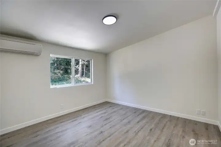 Comfortable primary suite offers a walk-in closet, private bathroom, and mini-split system for year-round comfort.