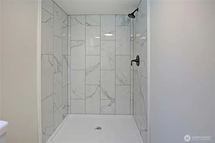 Primary bathroom custom tiled shower.